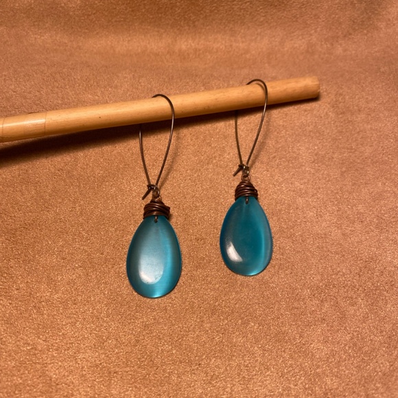 Peacock colored drop earrings with brass colored metal hoops. - Picture 2 of 3